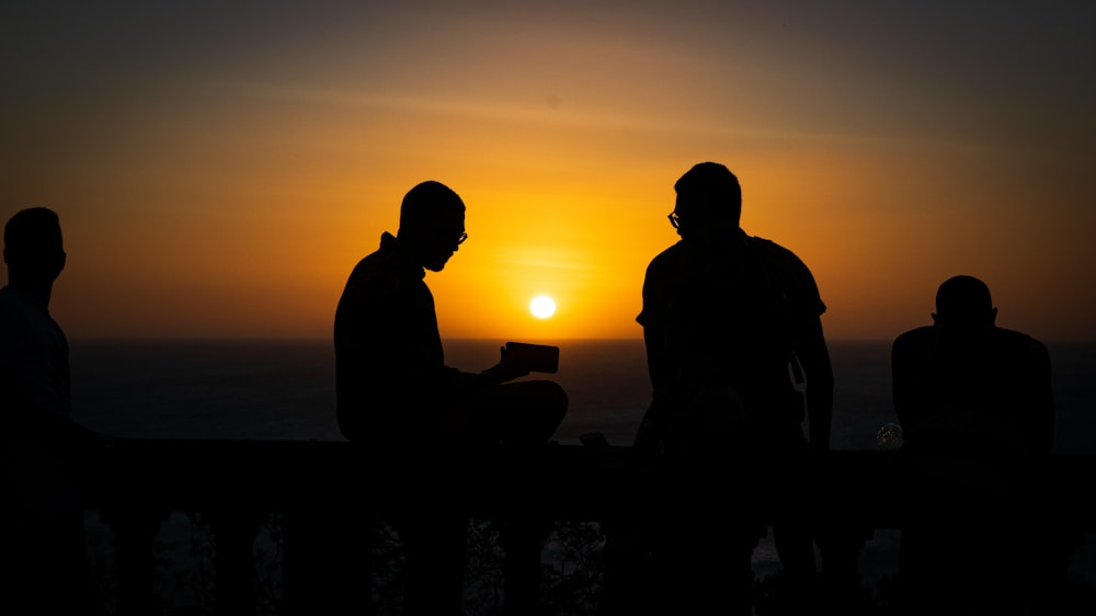 silhouette of four people