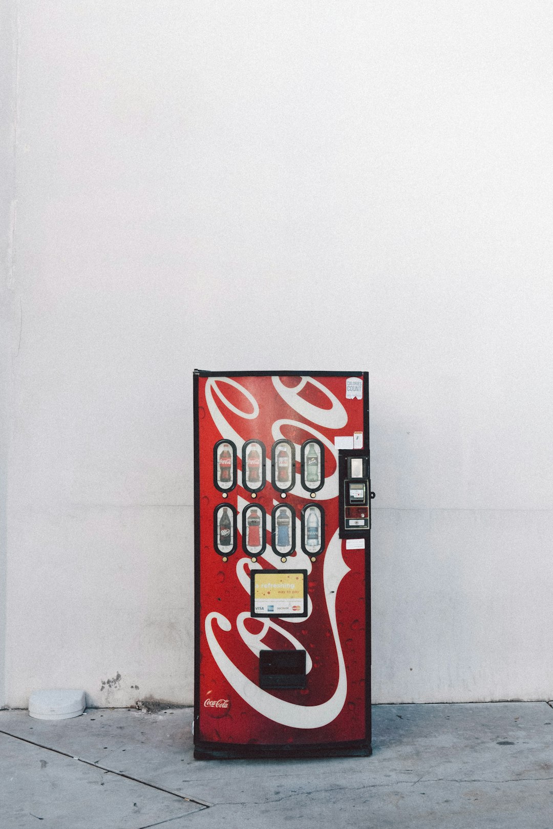 red and white Coca Cola dispenser