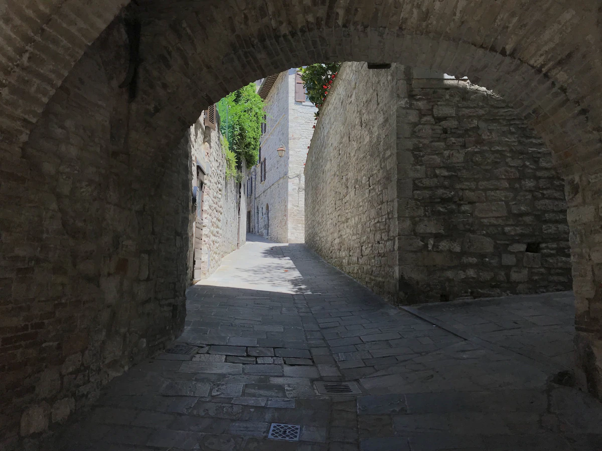 Narrow medieval alley with stone arch