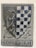 A stone relief featuring a heraldic shield. On the left, a detailed depiction of a bird with an elongated neck, likely an eagle or similar creature. The right side of the shield displays a checkered pattern of dark blue and white squares. Below the shield, the engraving reads 'DEGLI VBERTI'. The overall design is set against a rectangular stone background with subtle ornamental carvings.