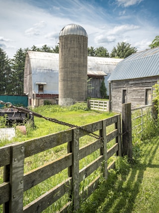 an old farm with a barn and a silo