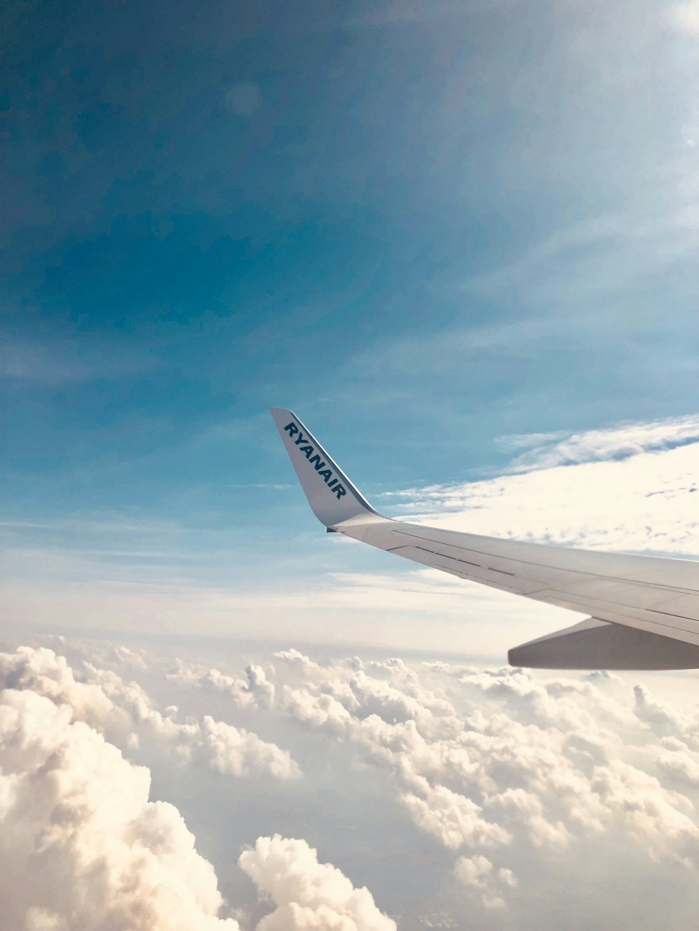 a view of the wing of an airplane in the sky