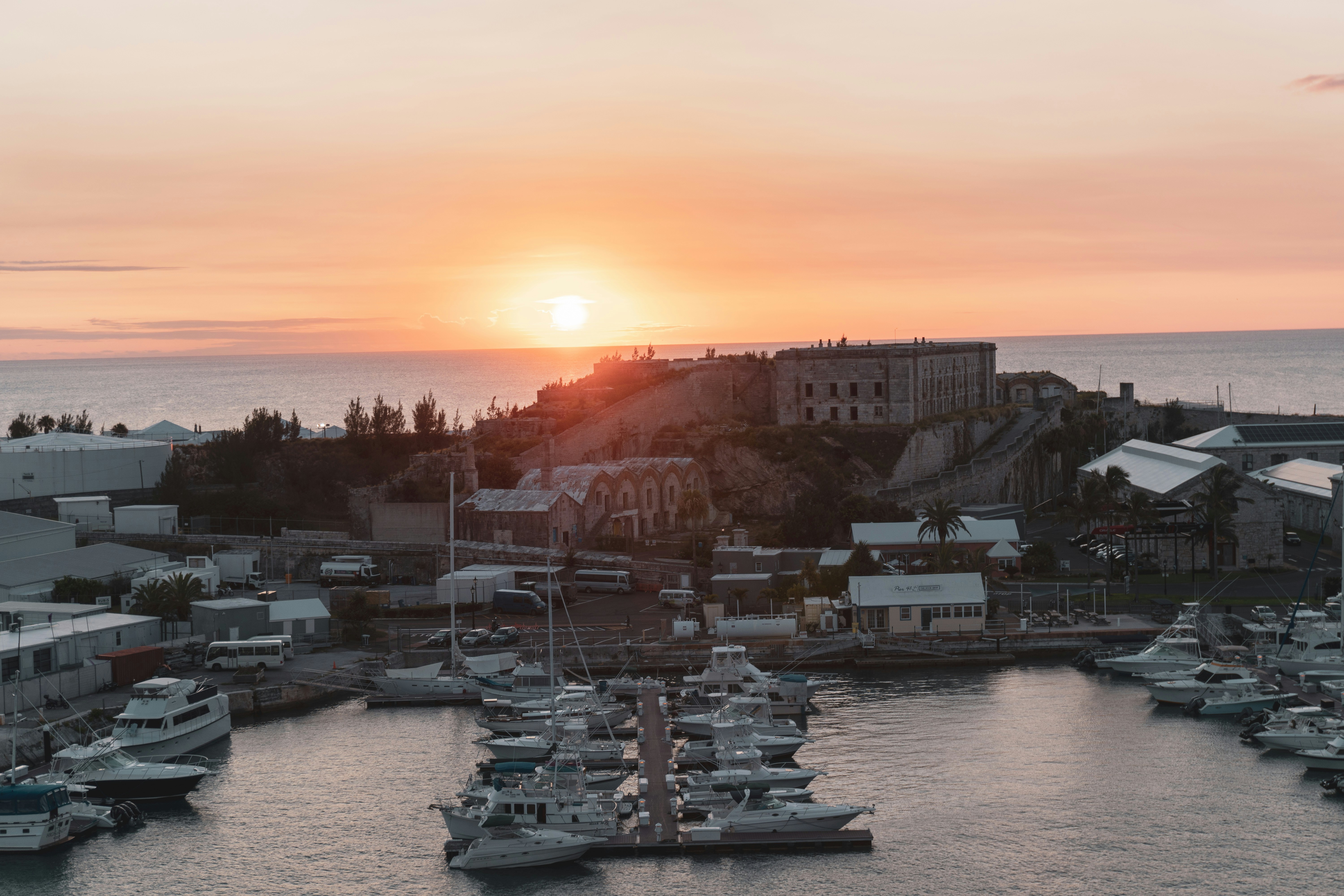 a harbor filled with lots of boats at sunset