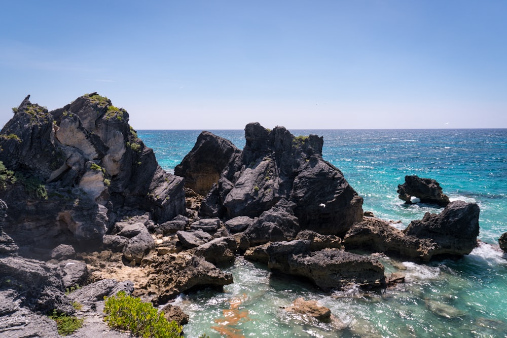 rocks near body of water at daytime