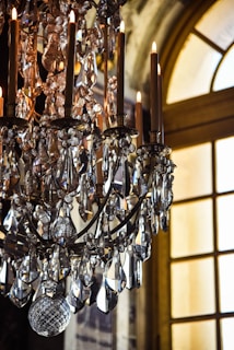 gold clear crystals chandelier near window
