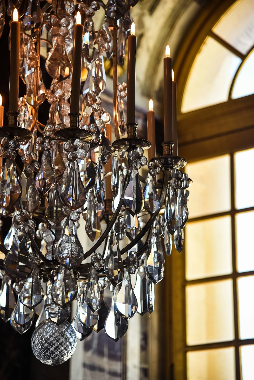 gold clear crystals chandelier near window