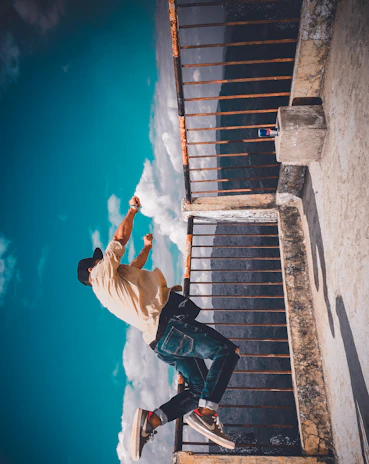 An energetic person mid-jump outdoors, holding a Power Grid drink, with a sunrise casting blue and green hues.