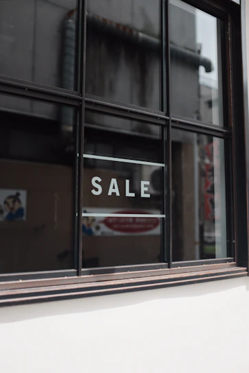 Close-up of a durable vinyl banner with clear text advertising a property sale.
