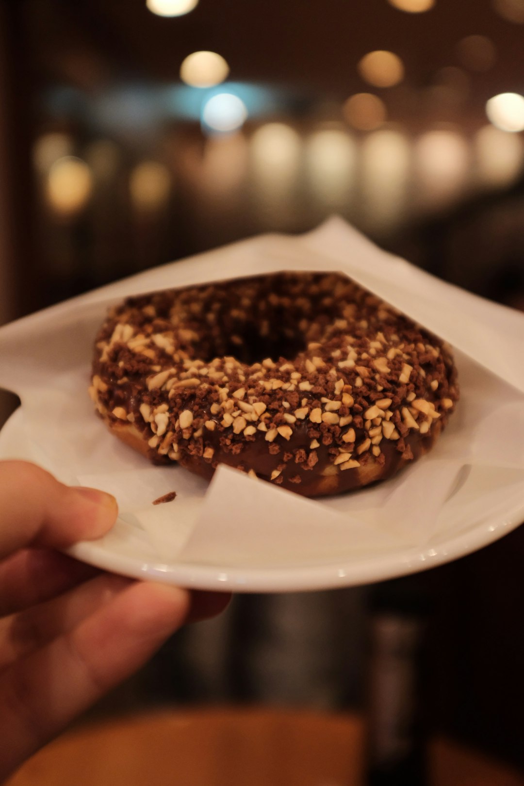 brown doughnut with peanut and chocolate