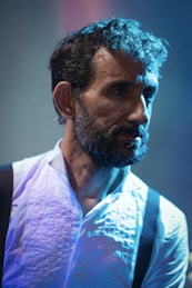 Acting coach man in a white shirt and black suspenders