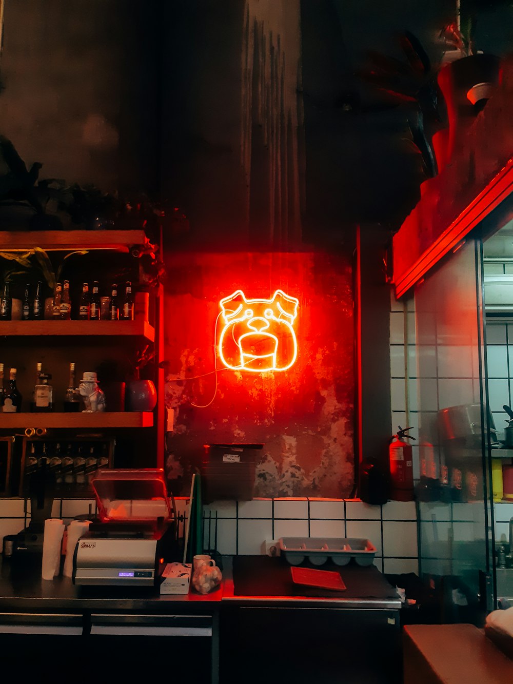 red and yellow bulldog LED light inside bar at night time