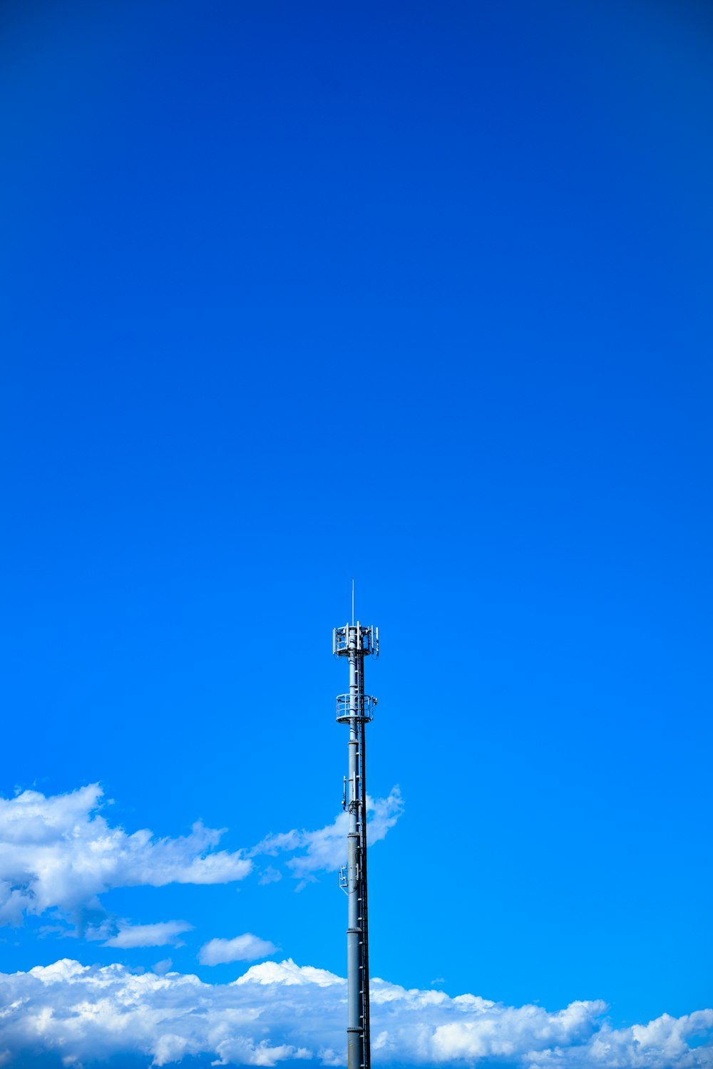 gray tower under blue cloudy sky