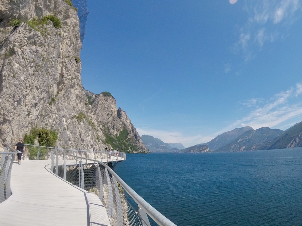 a person walking on a bridge over a body of water