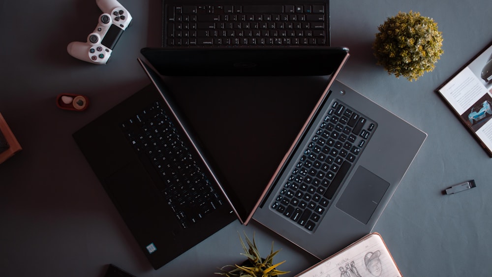three black and grey laptops