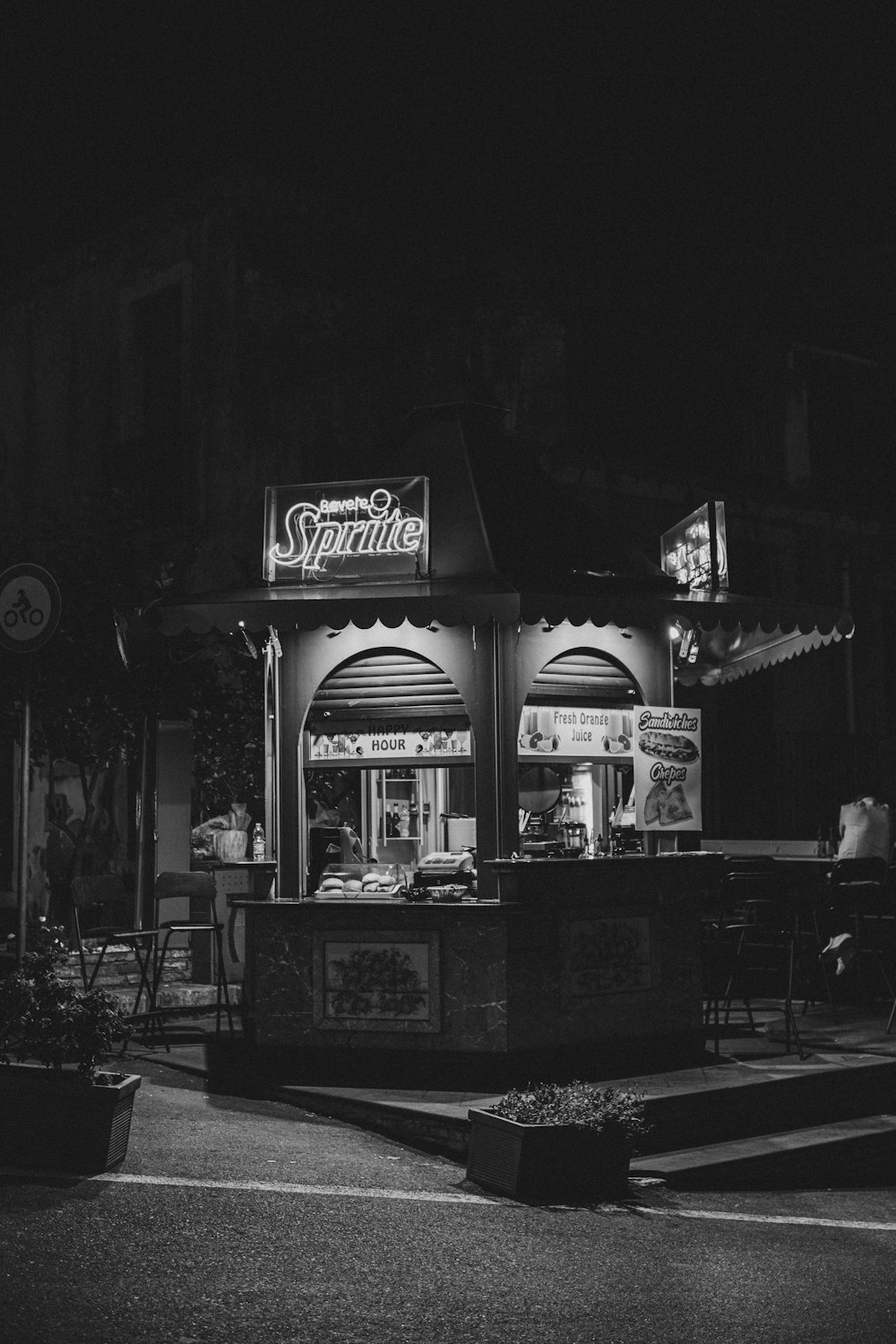 a black and white photo of a store at night