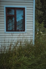 white and brown-framed window