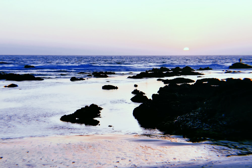 waves crashing coastal rock during daytime