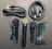 A collection of audio equipment including three microphones of different designs, several audio cables, and a black zippered pouch. The microphones feature both silver and black grills, and the cables have various connectors like XLR and quarter-inch jacks.