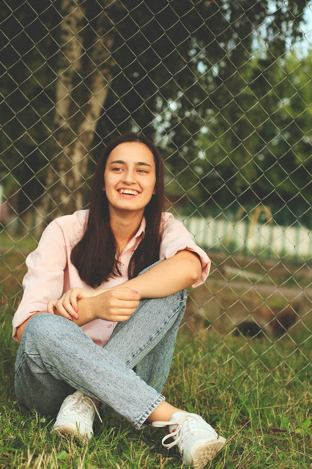 woman sitting near the fence