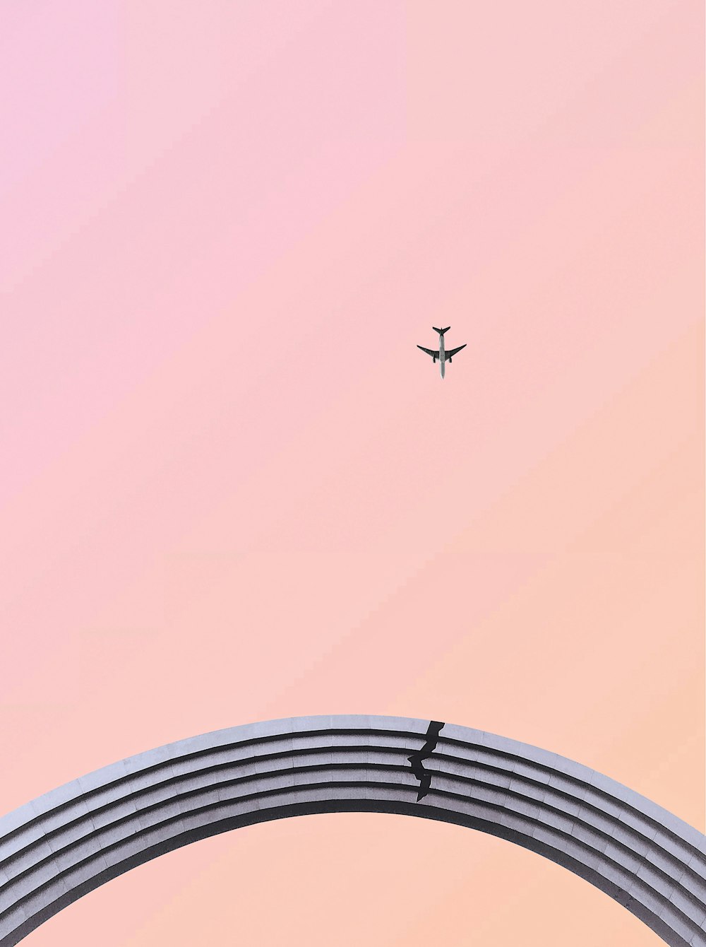 airplane in flight over pink sku