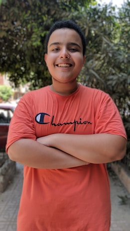 Smiling customer wearing a custom t-shirt outdoors, highlighting the shirt's vibrant colors.