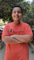 A happy customer wearing a soft oversized high neck t-shirt, standing outdoors with a relaxed smile.
