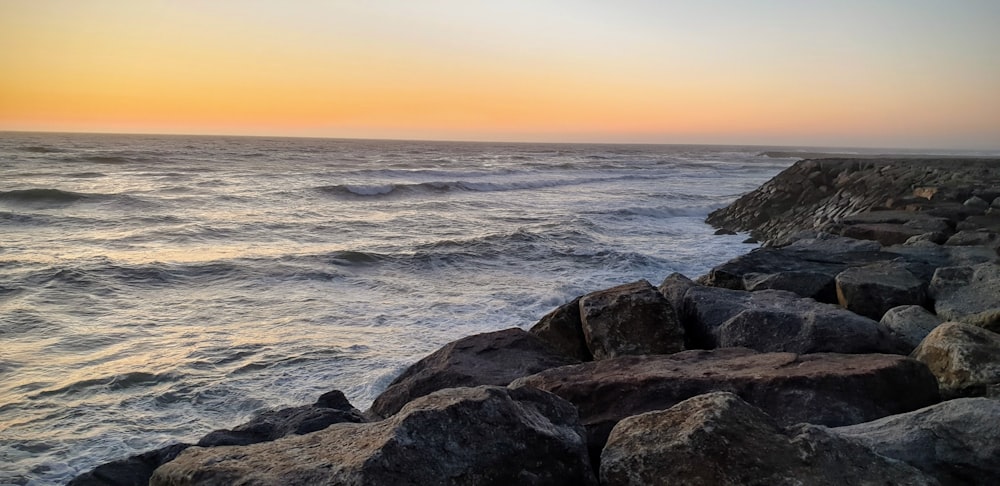 grey rocky shore during sunset