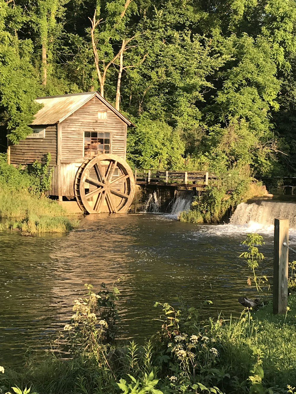 wooden water wheel on river