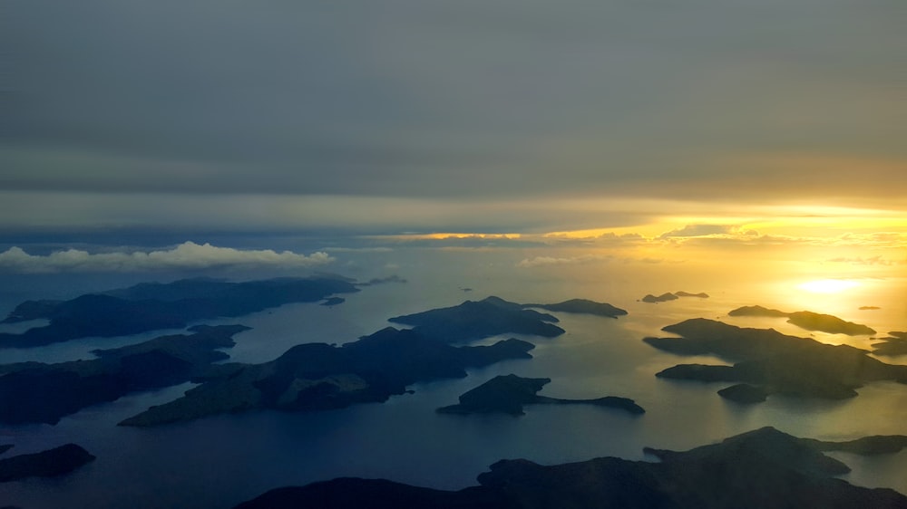 the sun is setting over a large body of water