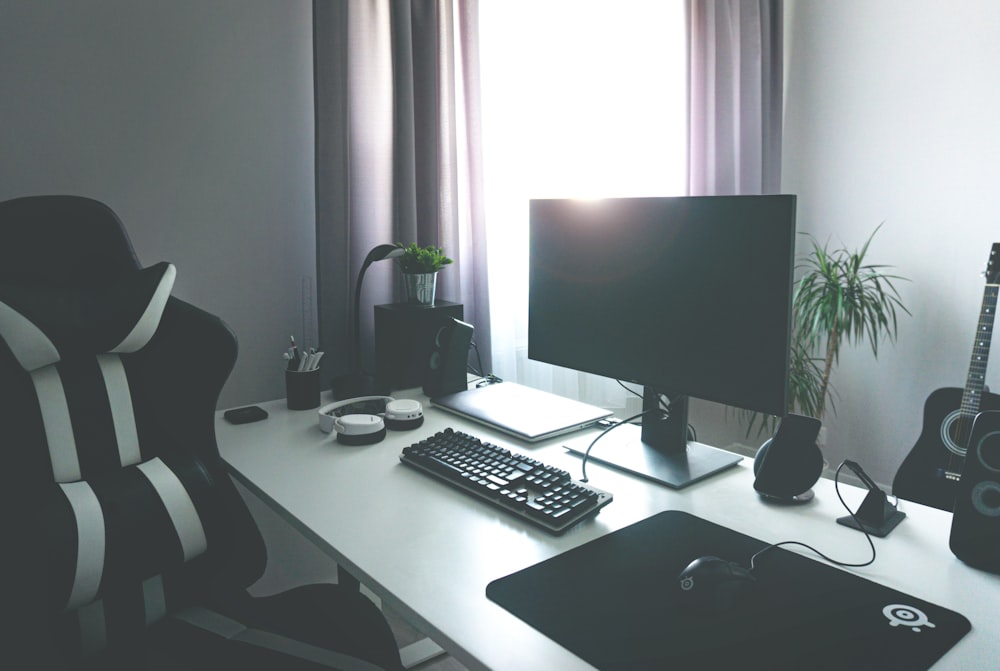 Black Flat Screen Computer Monitor On White Wooden Desk Photo