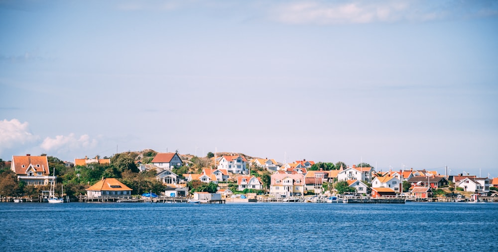 assorted-color houses beside sea