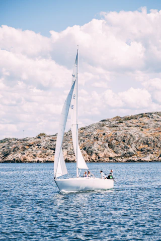 A serene sailing trip on the Sicilian coast under a clear blue sky.
