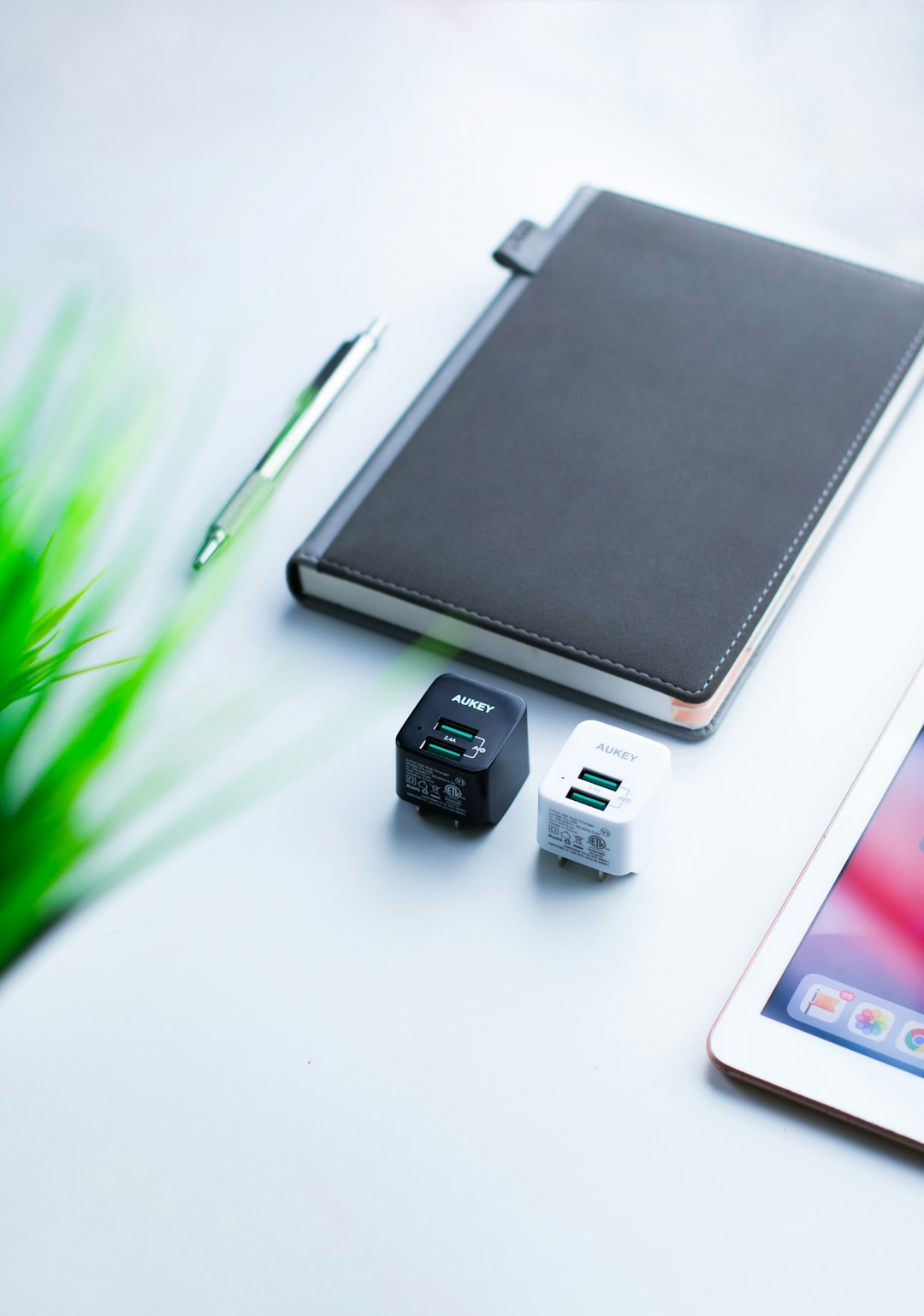 black planner beside two USB wall charger adapters