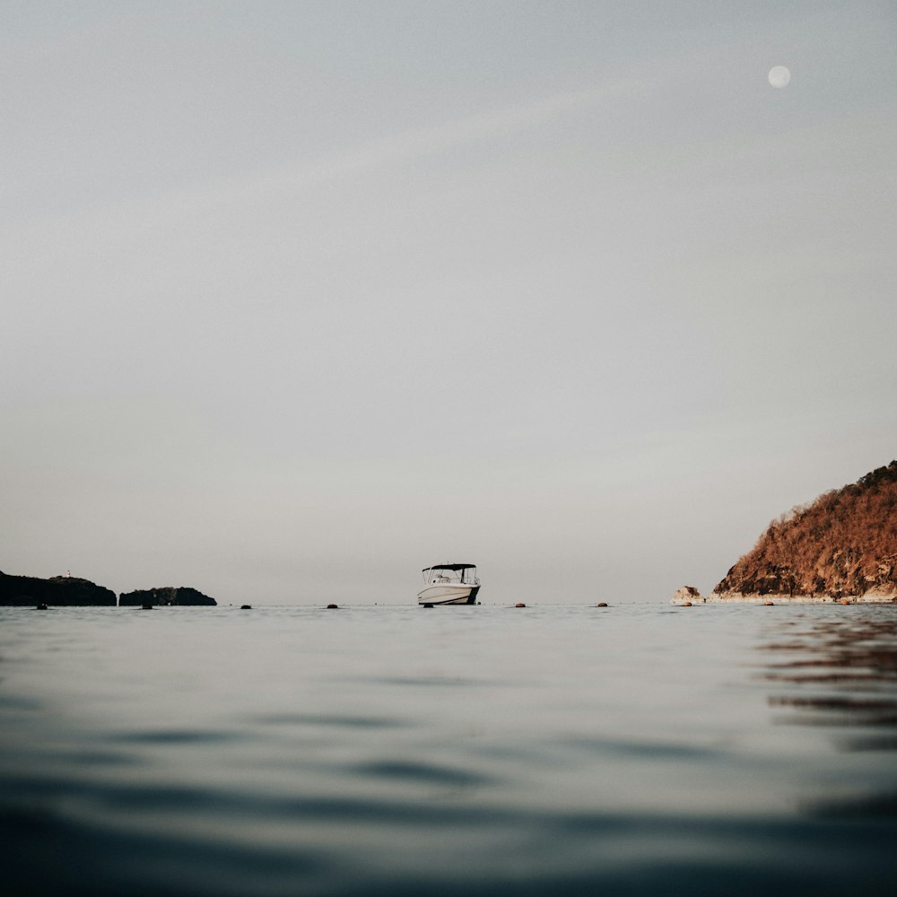 a boat floating on top of a large body of water