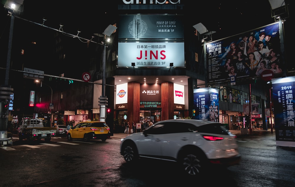 running SUV in front of Jins building