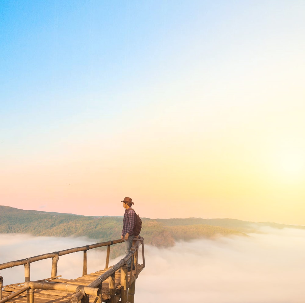 man standing on edge during daytime