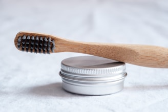 brown wooden toothbrush powder tin