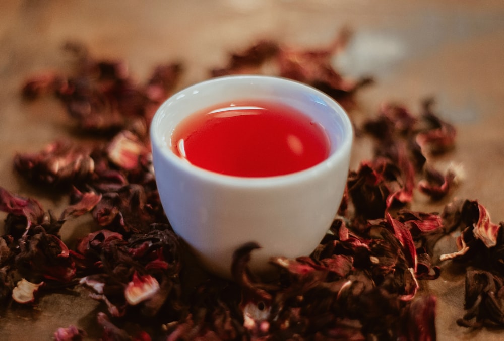 white ceramic cup with red liquid