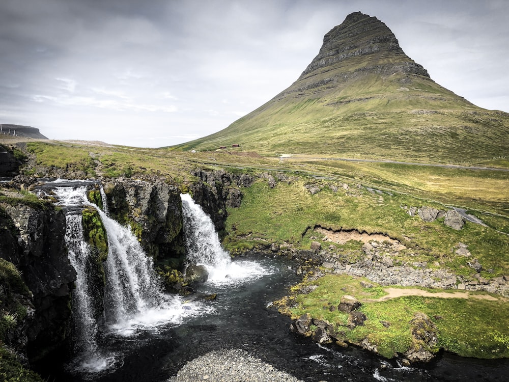 time-lapse photography of flowing waterfalls on mountain slope