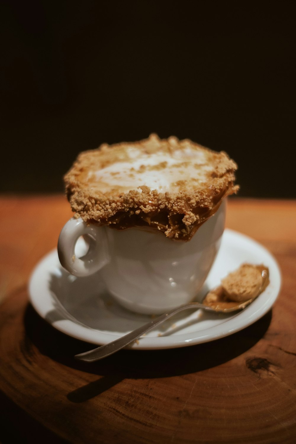 white ceramic mug with spoon on saucer