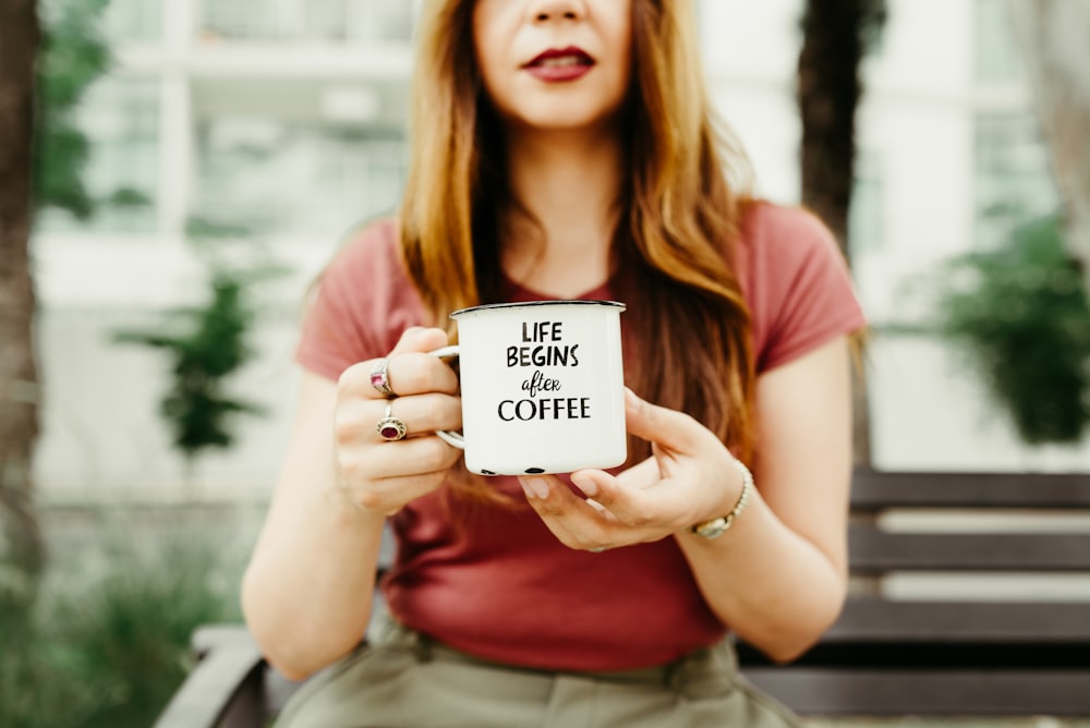 woman holding mug during daytime