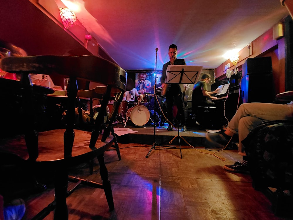 man standing stage in room