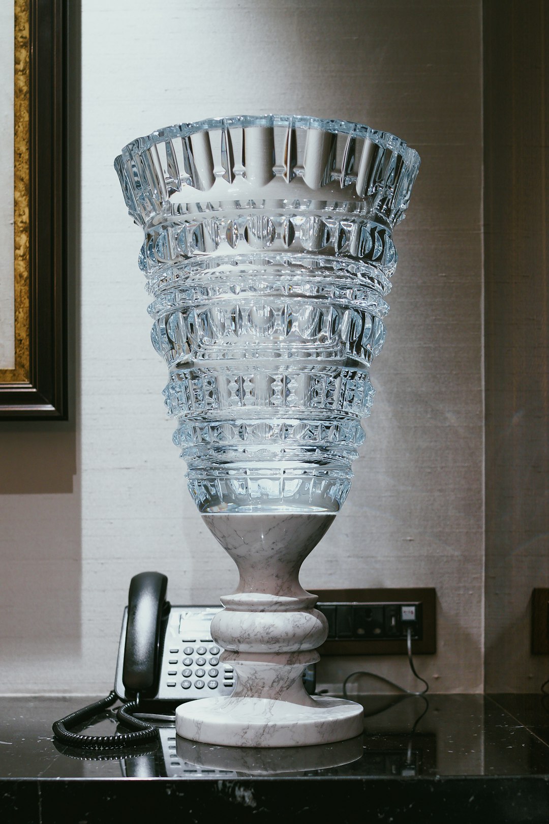 clear glass vase beside telephone on table