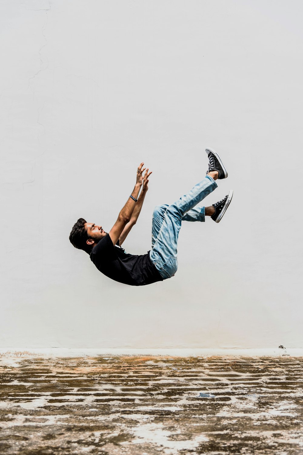 man in black T-shirt falling