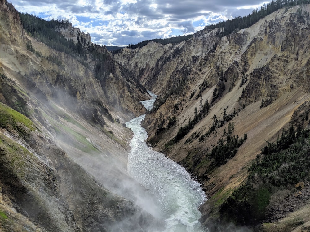 river in between mountains during daytime