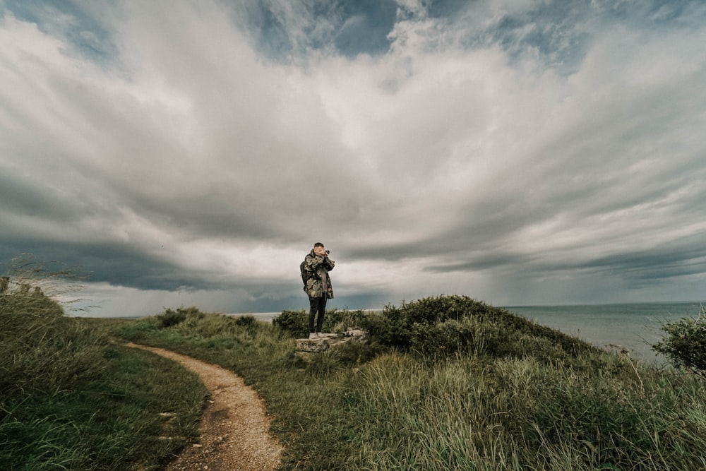 man standing on cliff