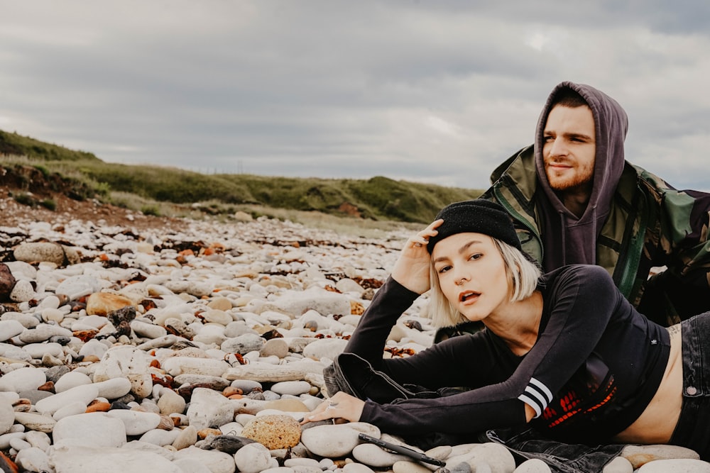 man sitting beside woman