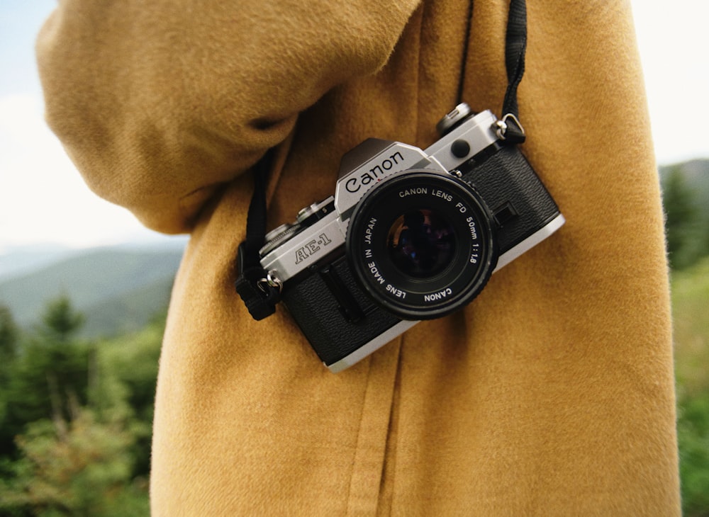 man wearing yellow coat with camera