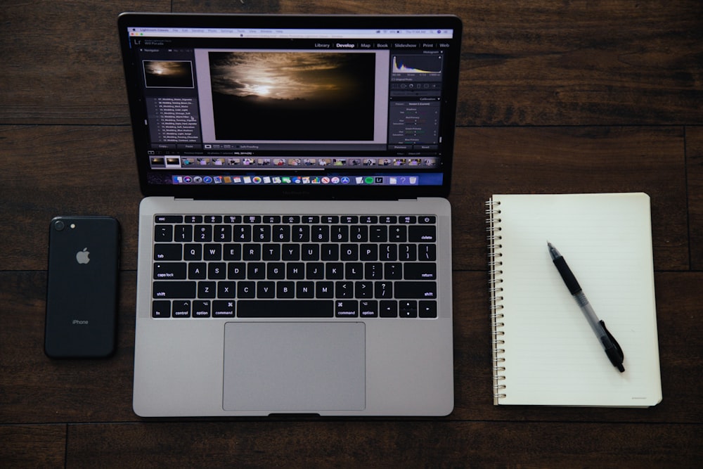 MacBook Pro near spiral notebook with pen on top and black iPhone 8 photo –  Free Phone Image on Unsplash