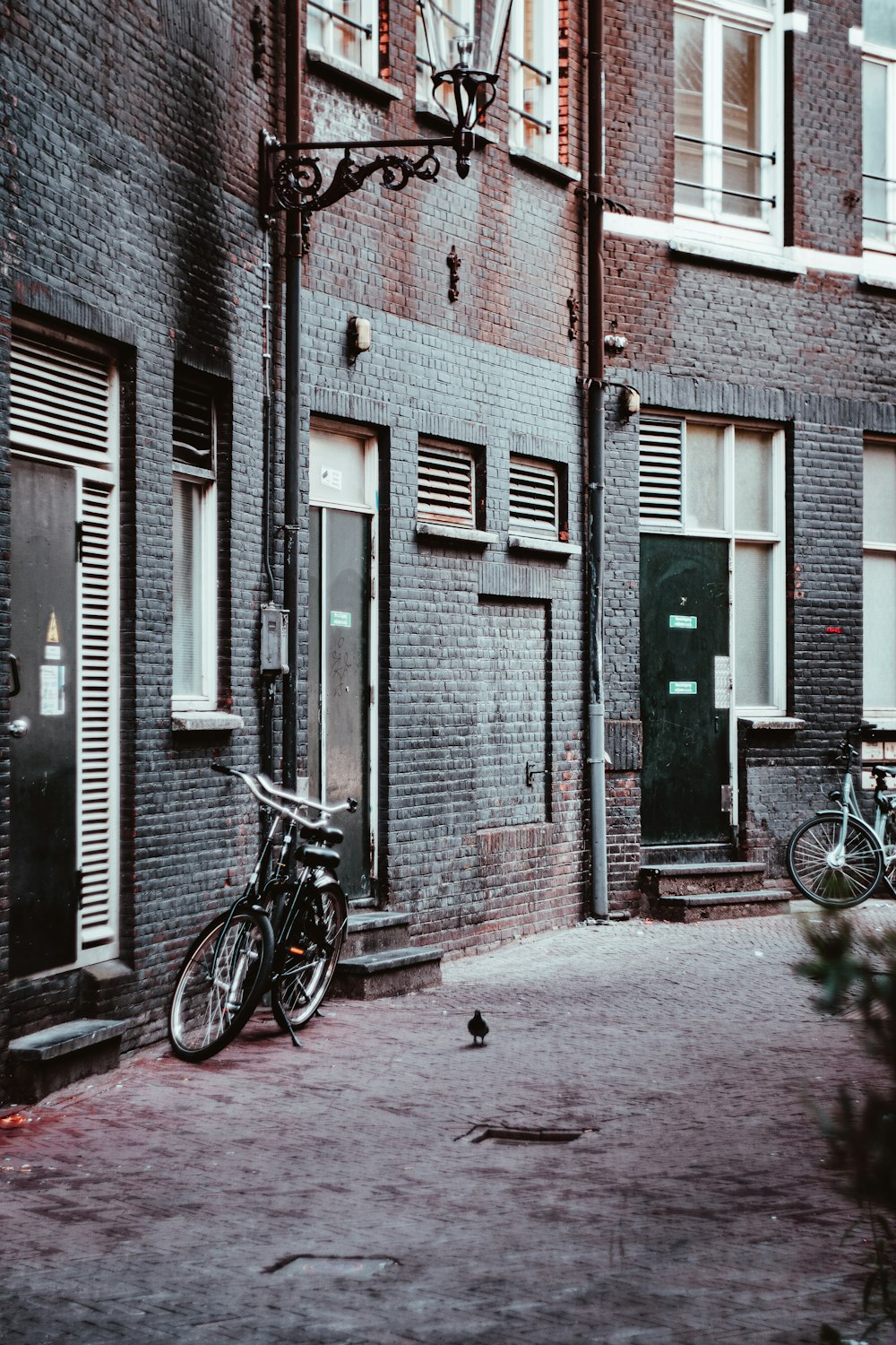 black bicycle parked beside house